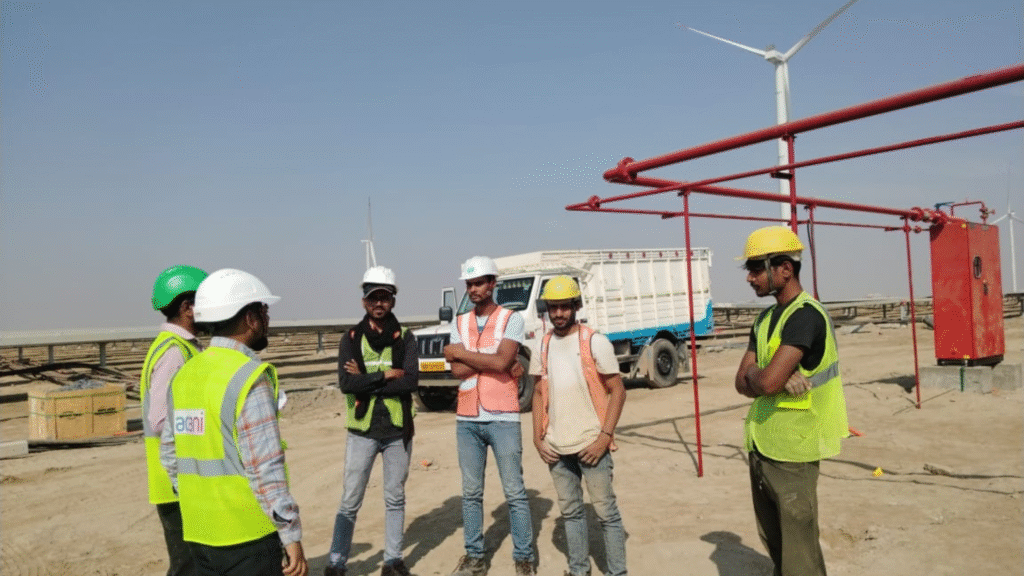 Engineers surveying a plot of land to plan a new ground-mounted solar panel installation