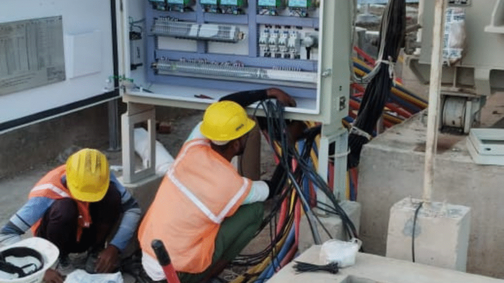Technicians working on the electrical wiring and commissioning of a solar panel system